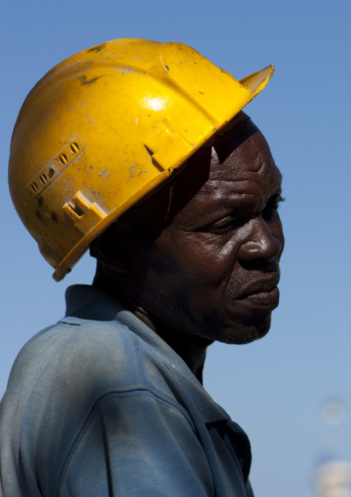 Kenyan worker wearing a yellow helmet, Lamu County, Lamu, Kenya