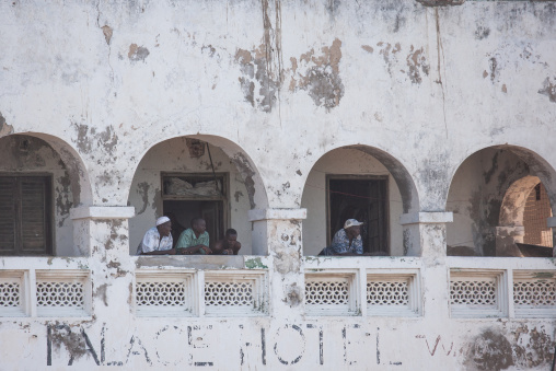 Men looking out of the balcony in Palace Hotel, Lamu County, Lamu, Kenya