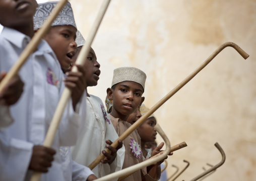 Muslim children dancing with sticks during Maulid festival, Lamu County, Lamu, Kenya