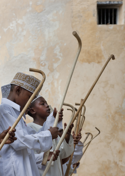 Muslim children dancing with sticks during Maulid festival, Lamu County, Lamu, Kenya