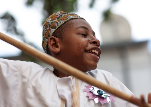 Muslim boy dancing with sticks during Maulid festival, Lamu County, Lamu, Kenya