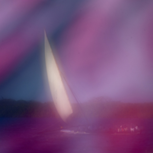 Dhow sailing seen thru a pink clothing, Lamu County, Lamu, Kenya
