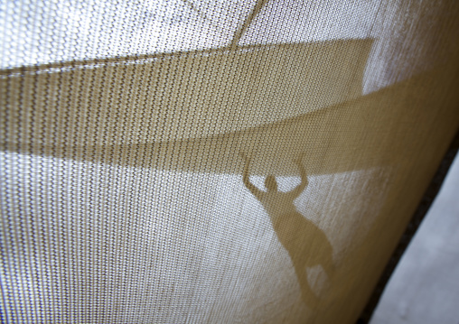 Man raising the sail on a dhow, Lamu County, Lamu, Kenya