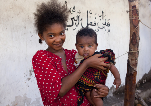 Young girl with baby boy, Lamu County, Lamu, Kenya