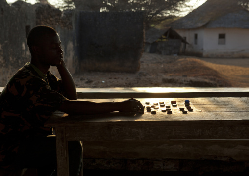 Player in front of a chessboard, Lamu County, Lamu, Kenya