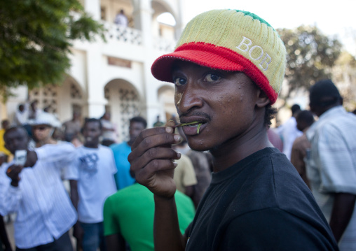 Young rasta man chewing qat in the street, Lamu County, Lamu, Kenya