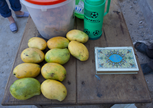 Mango fruit stall street vendor with a kuran book, Lamu County, Lamu, Kenya