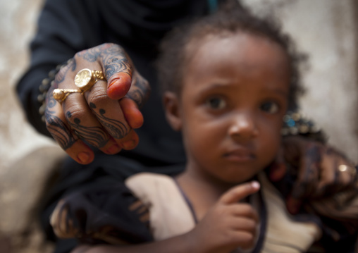 Muslim woman with henna painted hands and her daughter, Lamu County, Lamu, Kenya