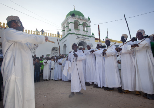 Muslim men singing and dancing with goma sticks during Maulid festival, Lamu County, Lamu, Kenya