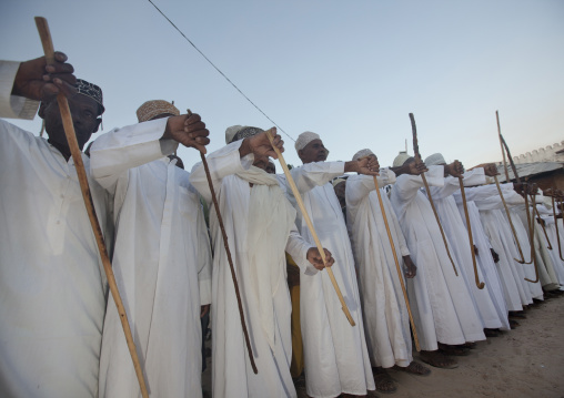 Muslim men singing and dancing with goma sticks during Maulid festival, Lamu County, Lamu, Kenya