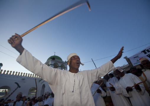 Muslim men singing and dancing with goma sticks during Maulid festival, Lamu County, Lamu, Kenya