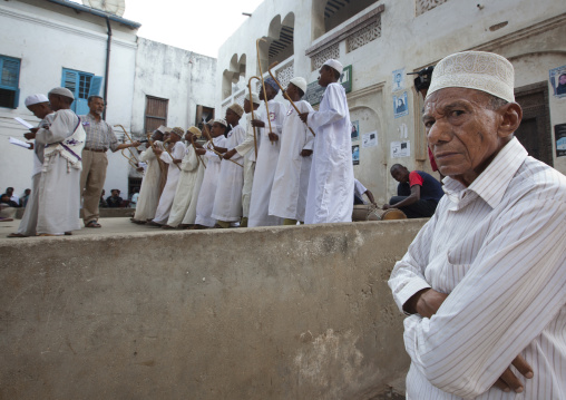 Muslim men singing and dancing with goma sticks during Maulid festival, Lamu County, Lamu, Kenya