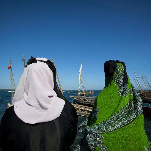 Two women in burqa looking at the sea, Lamu County, Lamu, Kenya