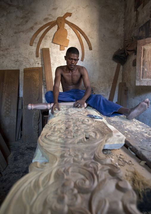 Wood carver making a door in his workshop, Lamu county, Lamu, Kenya