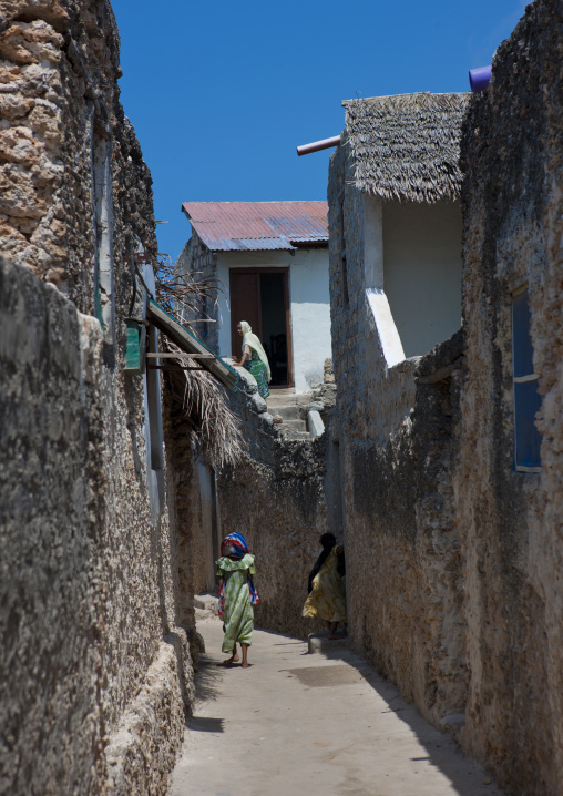 Woman walking in a narrow street, Lamu County, Pate Island, Kenya