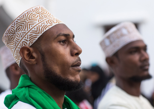 Sunni muslim men celebrating the maulidi festivities in the street, Lamu county, Lamu town, Kenya