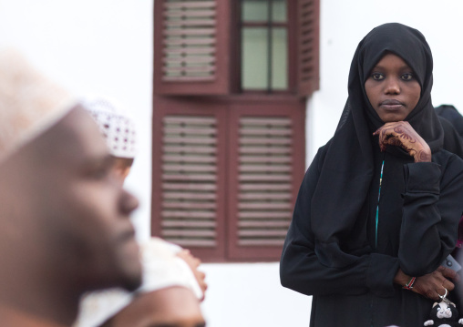 Muslim veiled young woman in the street during maulidi festivities, Lamu county, Lamu town, Kenya