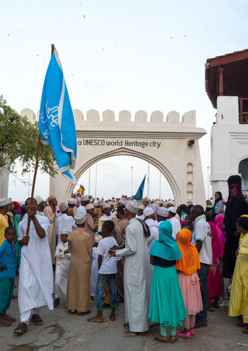 Sunni muslim people parading in front of the town gate during the maulidi festivities in the street, Lamu county, Lamu town, Kenya