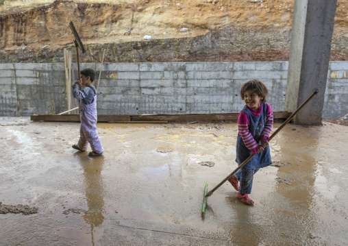 Yezidi Refugees Displaced From Sinjar Living In An Under Construction Building And Cleaning After A Storm, Duhok, Kurdistan, Iraq
