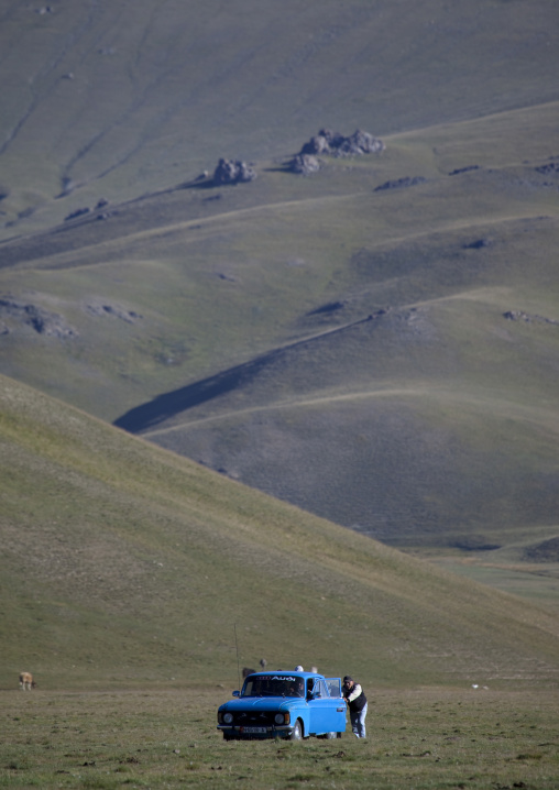Men Pushing An Old Lada Car In The Steppe, Jaman Echki Jailoo, Song Kol Lake Area, Kyrgyzstan