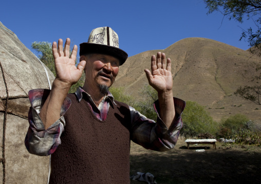 Old Man With Kalpak Hat Throwing Up His Hands, Kyzart River, Kyrgyzstan