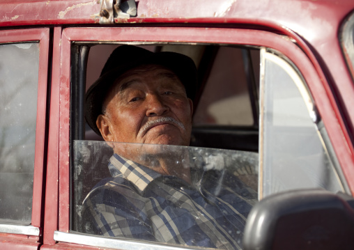 Old Man With A Hat Inside A Car At The Animal Market Of Kochkor, Kyrgyzstan