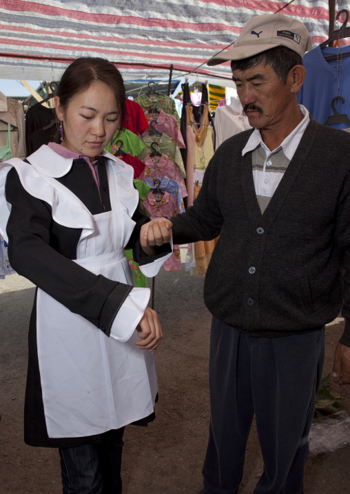 Young Woman Trying On A Dress, Animal Market Kochkor, Kyrgyzstan