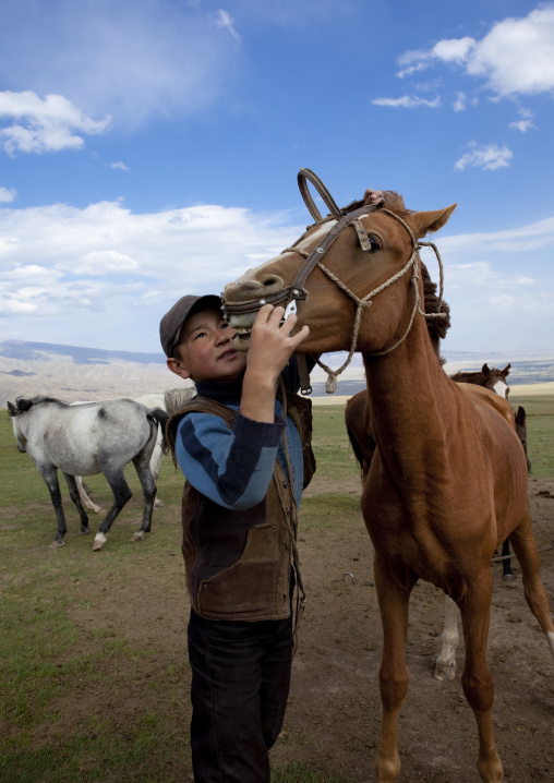 Boy With Cap Harnassing A Horse, Saralasaz Jailoo, Kyrgyzstan