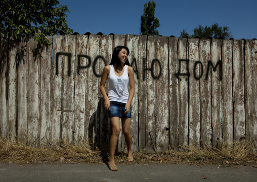 Beautiful Student Girl Posing In Front Of A House For Sale, Bishkek, Kyrgyzstan