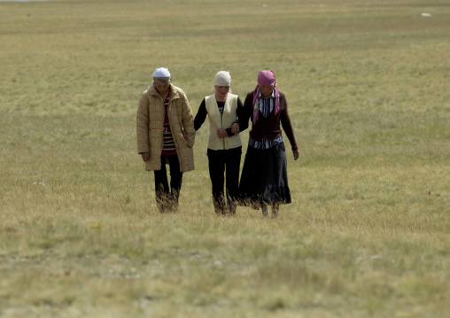 Women With Headscarves Walking In The Steppe, Song Kol Lake Area, Kyrgyzstan