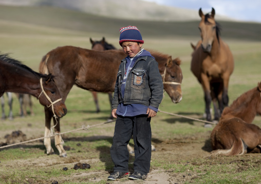 Boy In The Middle Of Horses, Jaman Echki Jailoo Village, Song Kol Lake Area, Kyrgyzstan