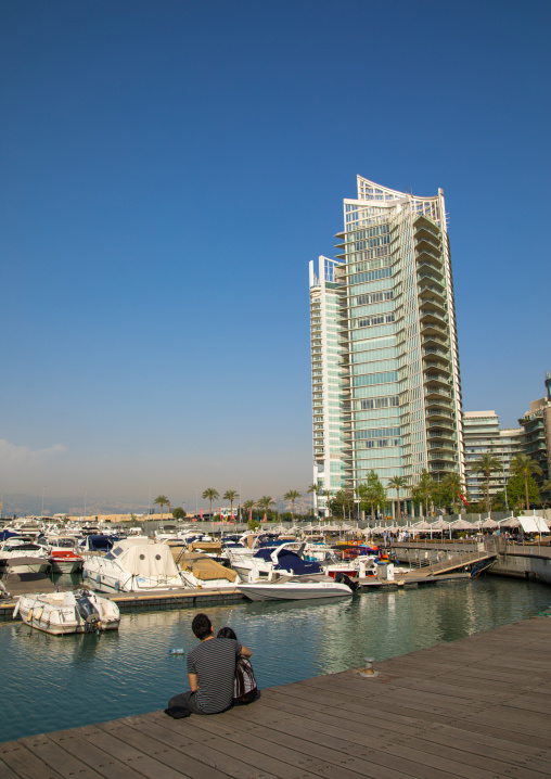 Couple in front of luxury residential buildings on the corniche, Beirut Governorate, Beirut, Lebanon
