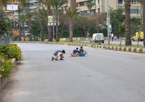 Syrian refugees children taking pictures in the middle of a road, North Governorate, Tripoli, Lebanon