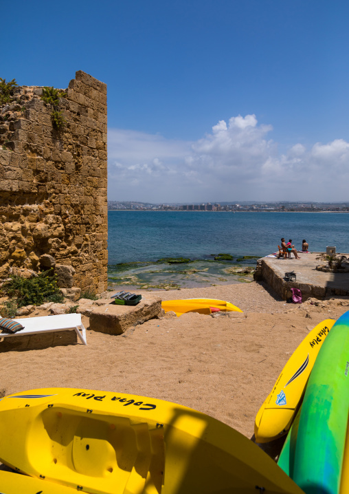 People sunbathing on a beach near a ruin, South Governorate, Tyre, Lebanon