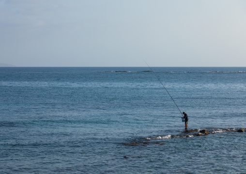 Lebanese man fishing on rocks, South Governorate, Tyre, Lebanon
