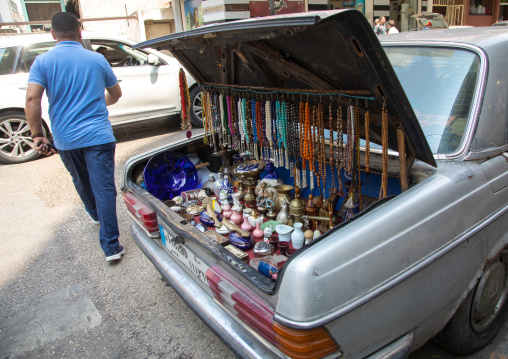 A man selling prayer beads and souvenir from the trunk of his car in the street, Beirut Governorate, Beirut, Lebanon