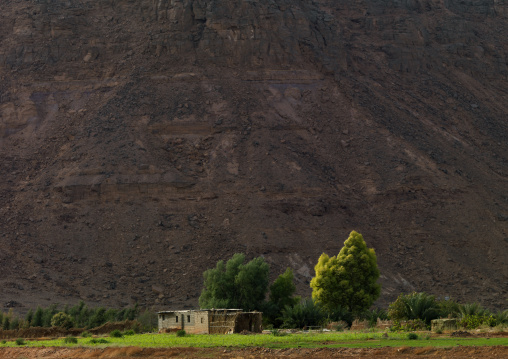 House in front of a mountain, Fezzan, Al-Hatia, Libya