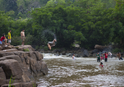 Kids jumping in tadfan waterfalls, Boloven, Laos