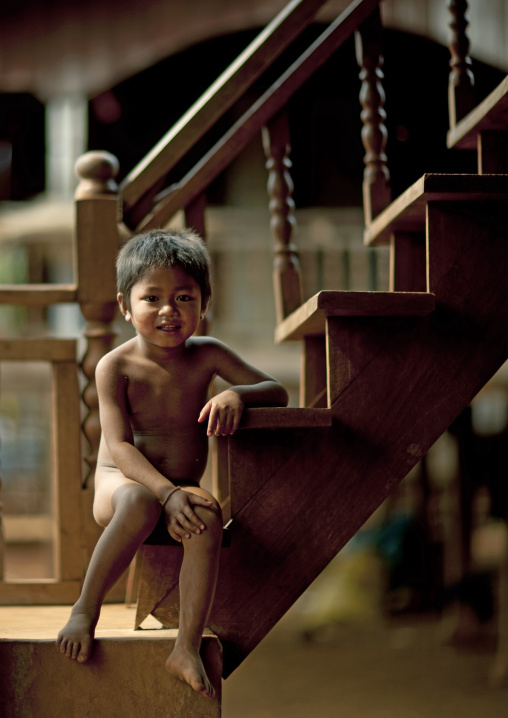 Bru kid sitting on stairs, Katou, Laos