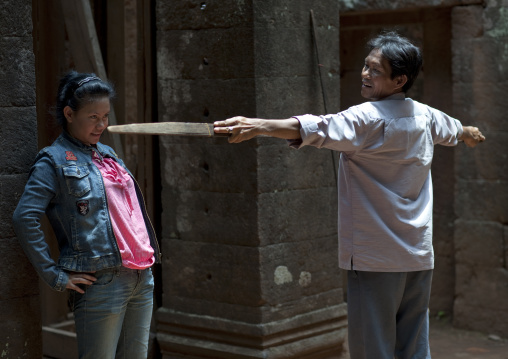 Men inside wat phu champasak khmer temple, Champasak, Laos