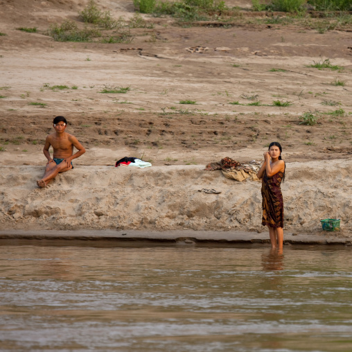 Laotian people taking bath on mekong river, Houei xay, Laos