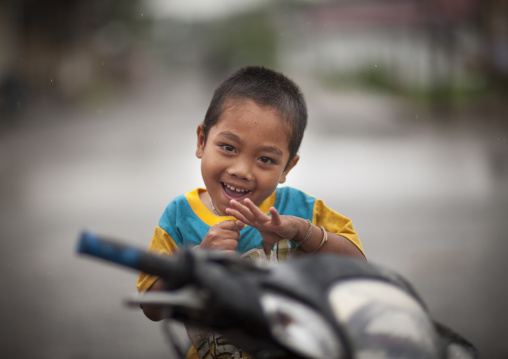 Smiling kid on a motorbike, Houei xay, Laos