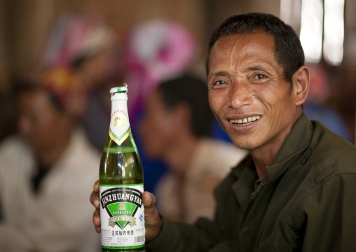 Akha minority man drinking beer, Ban ta mi, Laos