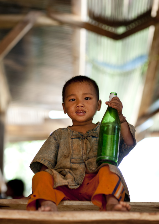 Akha minority boy holding a beer bottle, Ban ta mi, Laos