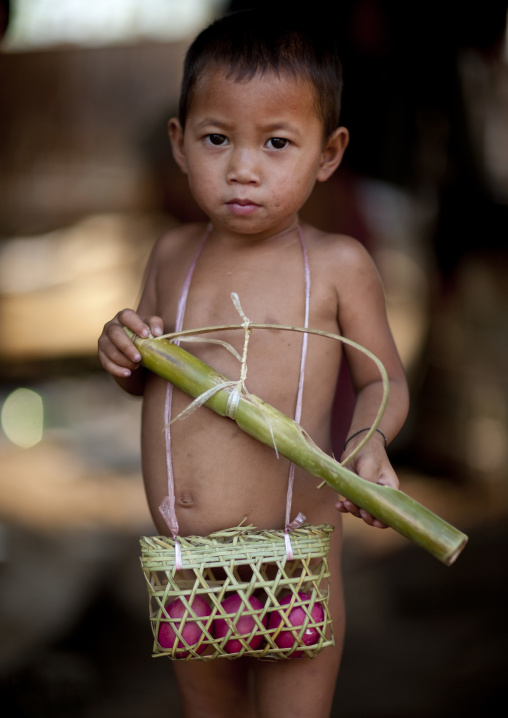 Akha minority boy with a basket of eggs, Muang sing, Laos