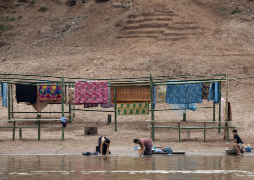 People washing clothes for lao new year on mekong river, Luang prabang, Laos