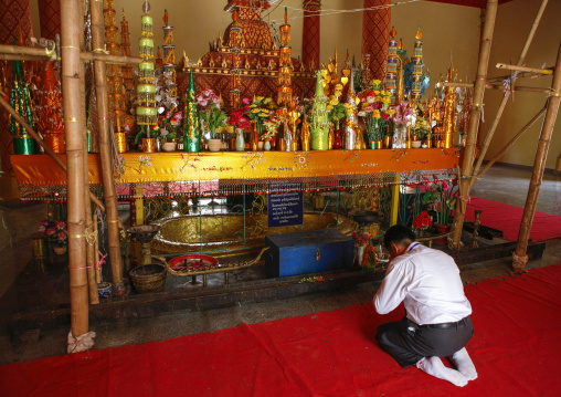 Man praying in a temple, Vientiane, Laos