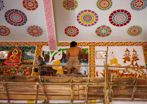 Man painting in a temple, Vientiane, Laos
