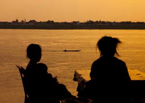 People in front of mekong river at sunset, Thakhek, Laos