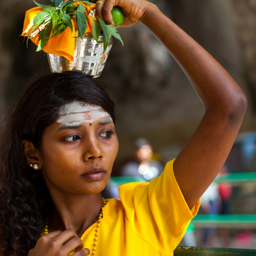 Hindu Devotee Woman Carrying Water Jug On Her Head In Annual Thaipusam Religious Festival In Batu Caves, Southeast Asia, Kuala Lumpur, Malaysia